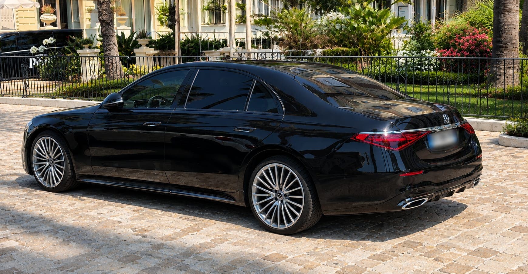 Black Mercedes S-Class in front of a French Riviera palace hotel